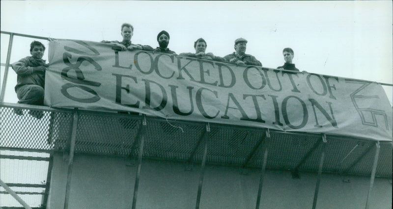 On February 9, 1987, students at Oxford Polytechnic protested against rising tuition fees by climbing to the top of a water tower and unfurling a banner. - Vintage Photograph