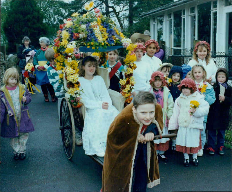 Eleven-year-old Michael Hall pulling May Queen Maria Tapp in a May Day procession. - Vintage Photograph