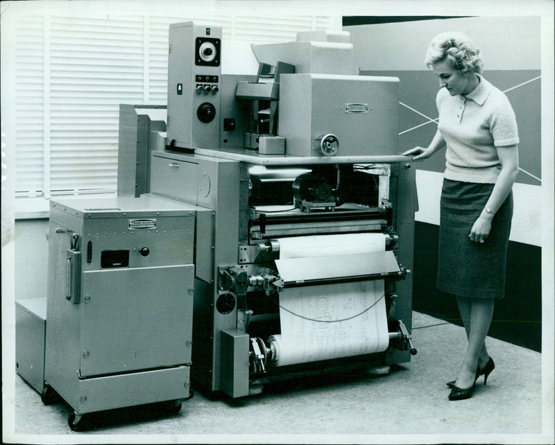 A Rank-Xerox Copyflo continuous printer prints out university applications at twenty feet a minute. - Vintage Photograph