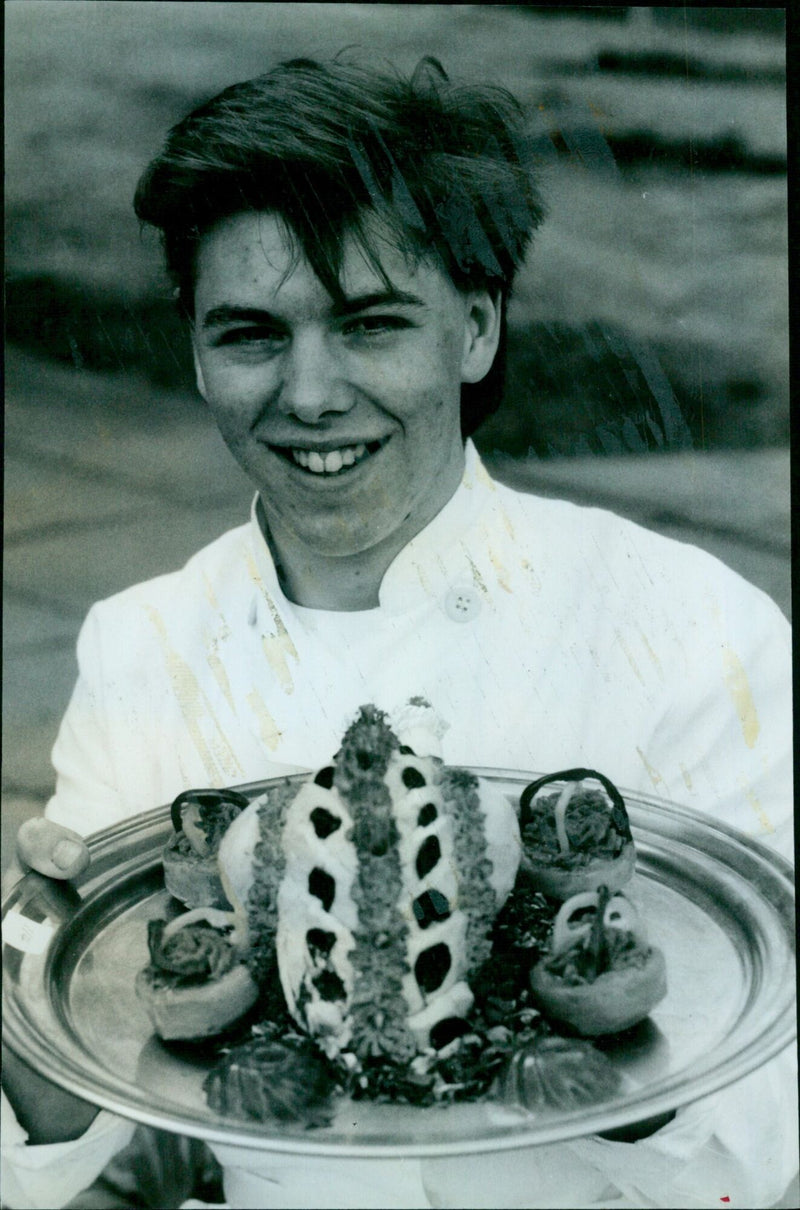 Simon Joyce, a student from Christ Church College, showcases his dressed chicken exhibit at Oxford Polytechnic's catering presentation. - Vintage Photograph