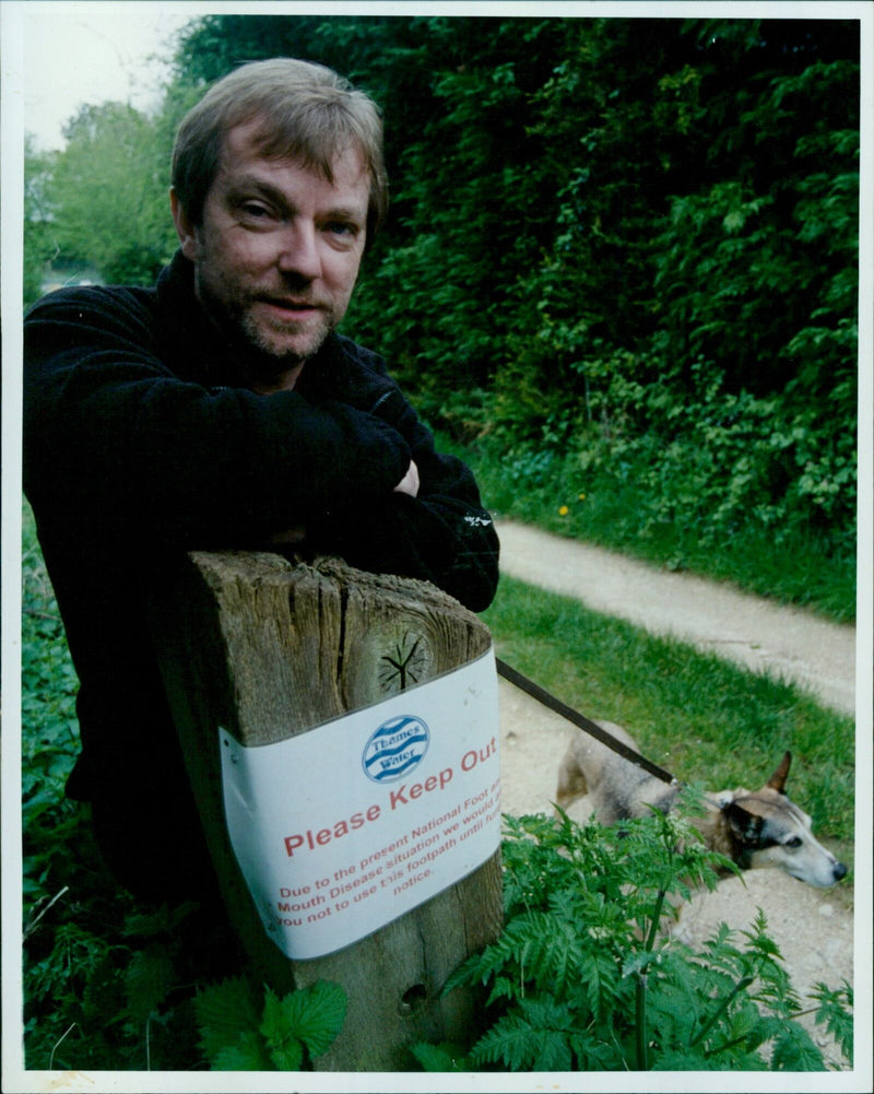 John Woodruffe and his dog, Megan, stand before a footpath near a reservoir closed off due to the National Foot and Mouth Disease situation. - Vintage Photograph