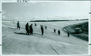 Firefighters unload 43 water tanks from three trucks. - Vintage Photograph