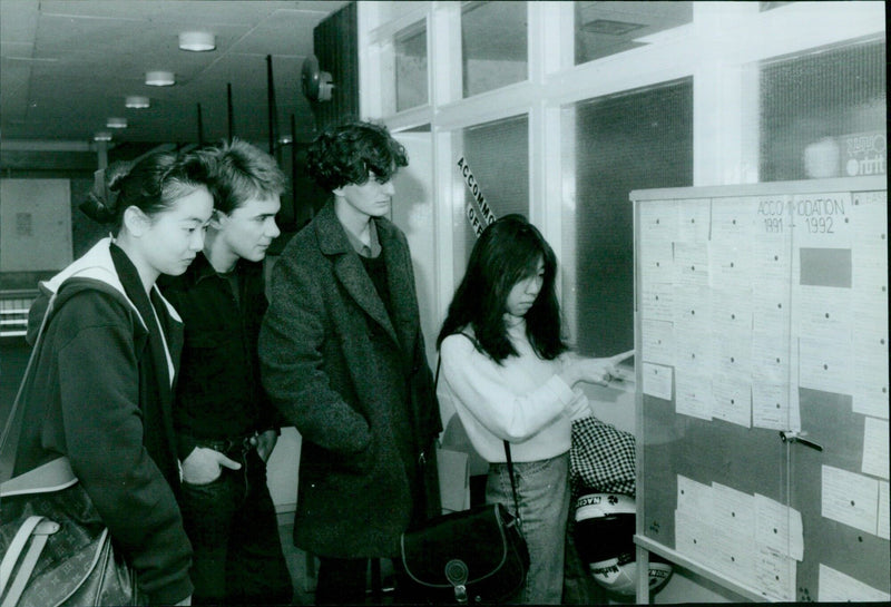 Students at Oxford Polytechnic review the accommodation board. - Vintage Photograph