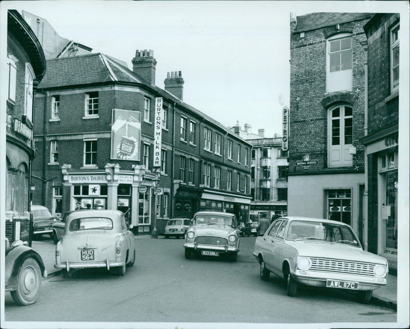 Cars line the street in Oxford, England on April 5, 1965. - Vintage Photograph