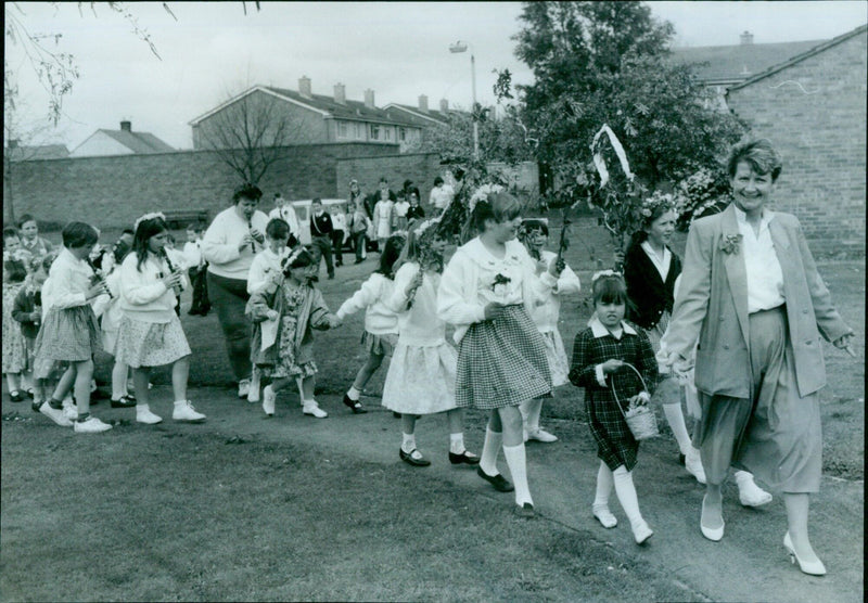 A teacher leads a May Day parade in Bletchingdon, Oxfordshire. - Vintage Photograph