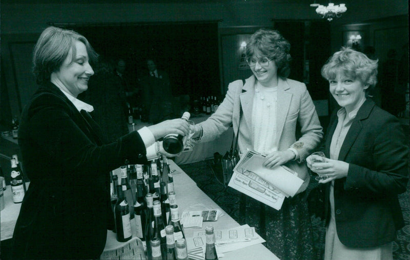 Customers browse the shelves of an Austrian wine shop. - Vintage Photograph