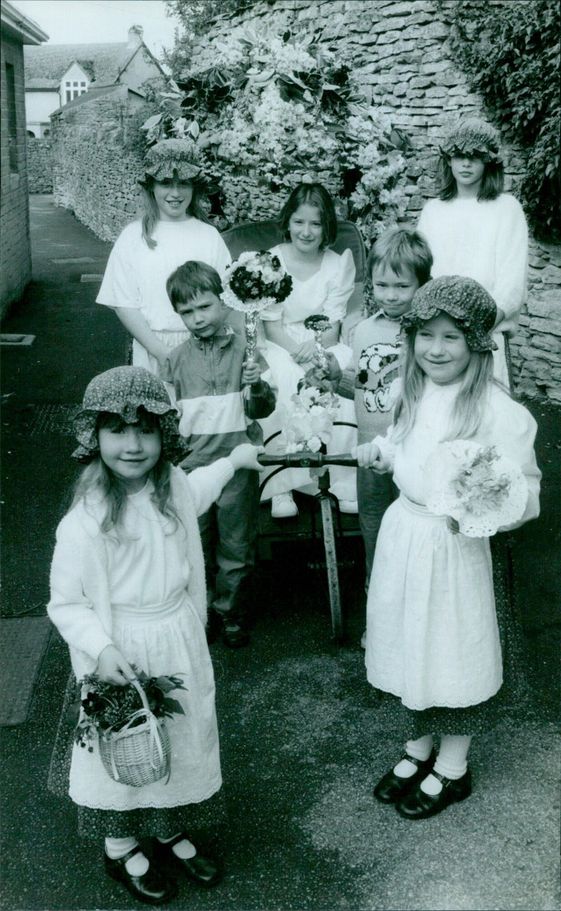 Two-year-old Clare Simpson is pulled in her chariot during the May Day parade in Combe. - Vintage Photograph