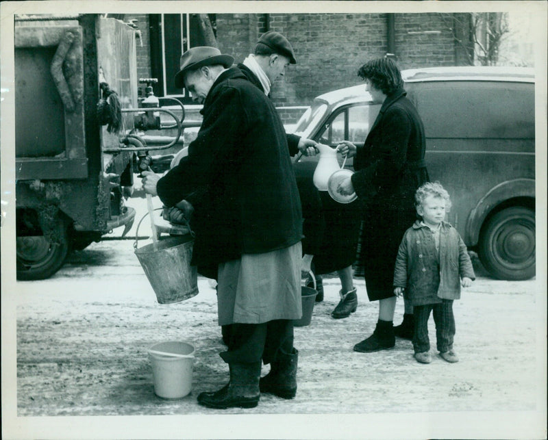 Residents of Alma Place in Cowley, England, collecting their morning ration of water from a lorry. - Vintage Photograph