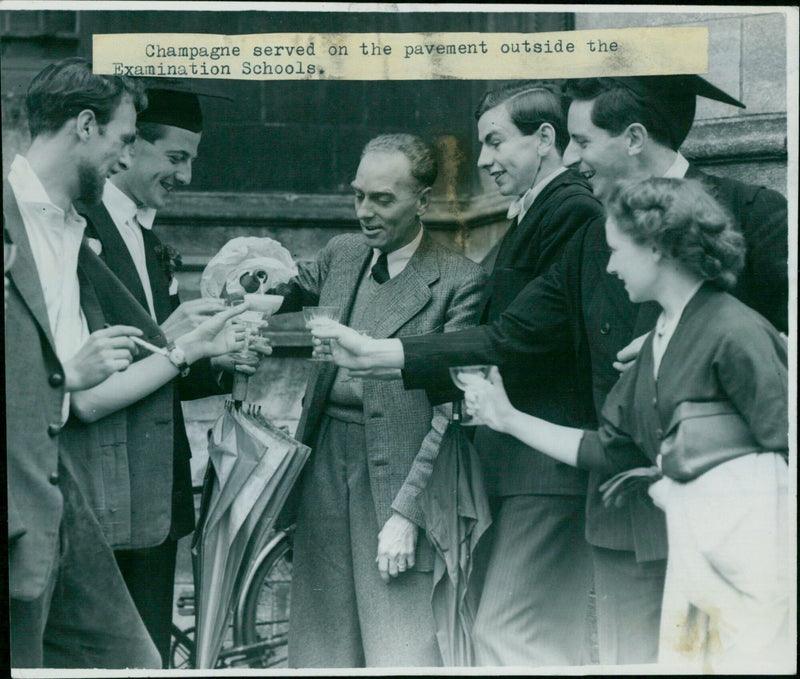 Oxford undergraduates celebrate their last day at the Examination Schools with champagne served on the pavement. - Vintage Photograph