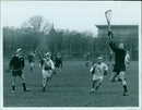 GR Berry leaps to collect the ball during a lacrosse match. - Vintage Photograph
