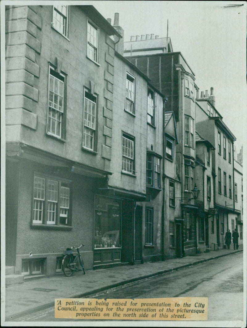 Residents of the city gather to petition for the preservation of the picturesque properties on the north side of a street. - Vintage Photograph