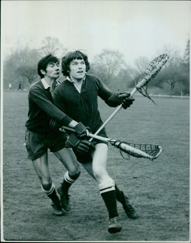 Oxford University lacrosse players practicing in the park in preparation for their upcoming match against Cambridge. - Vintage Photograph