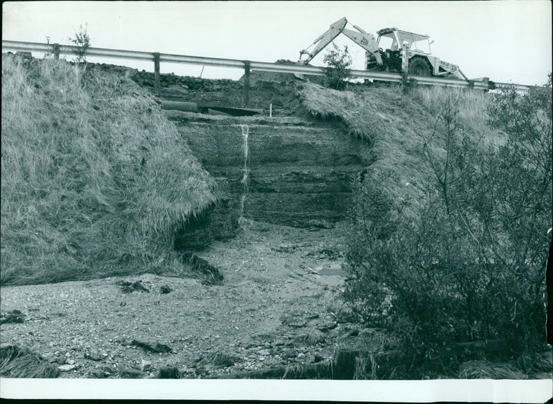 Washed out embankment with broken mains pipes on the Western By Pass. - Vintage Photograph