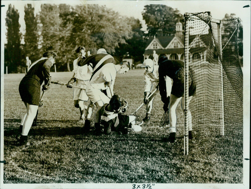 Oxford University goalkeeper K. Stevenson (Queen's) attempts to stop a London attack during a lacrosse match in the University Parks. - Vintage Photograph