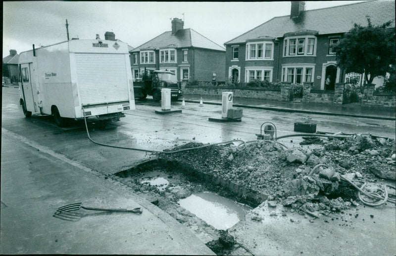 A burst water main in Cowley Road, Oxford, causes disruption to the local area. - Vintage Photograph