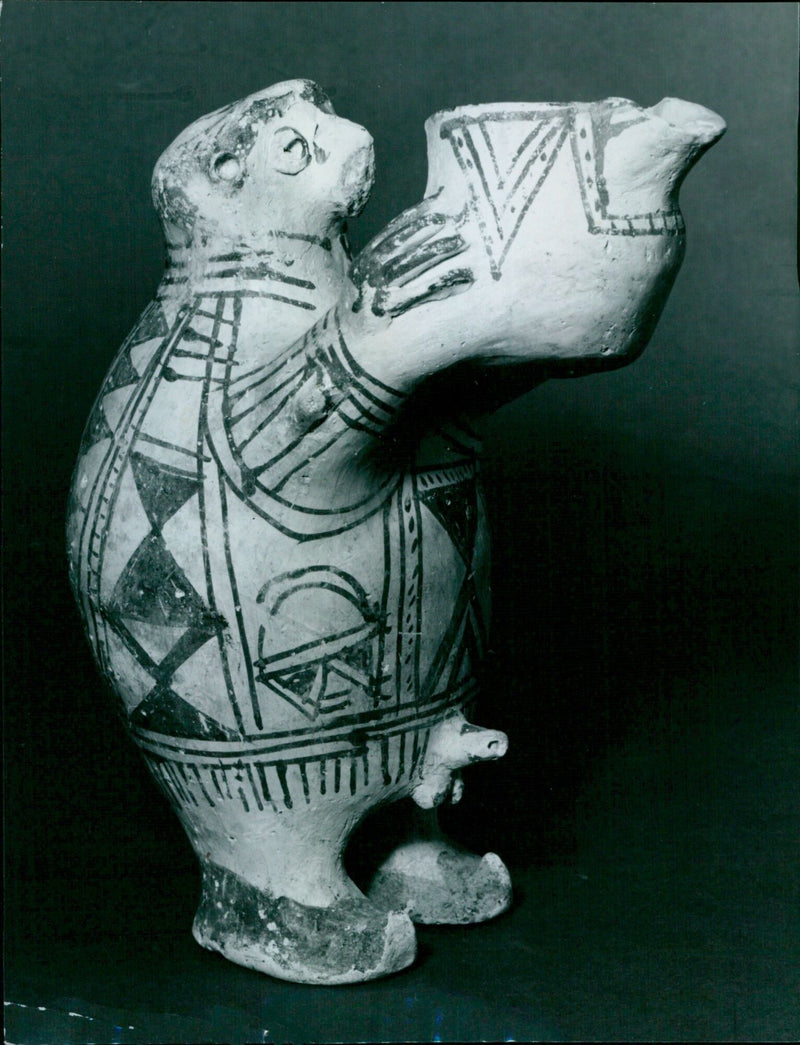 A Persian priest pouring a libation from a baked clay vessel. - Vintage Photograph