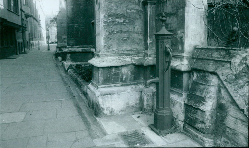 A water pump outside St Mary the Virgin church in February 1976. - Vintage Photograph