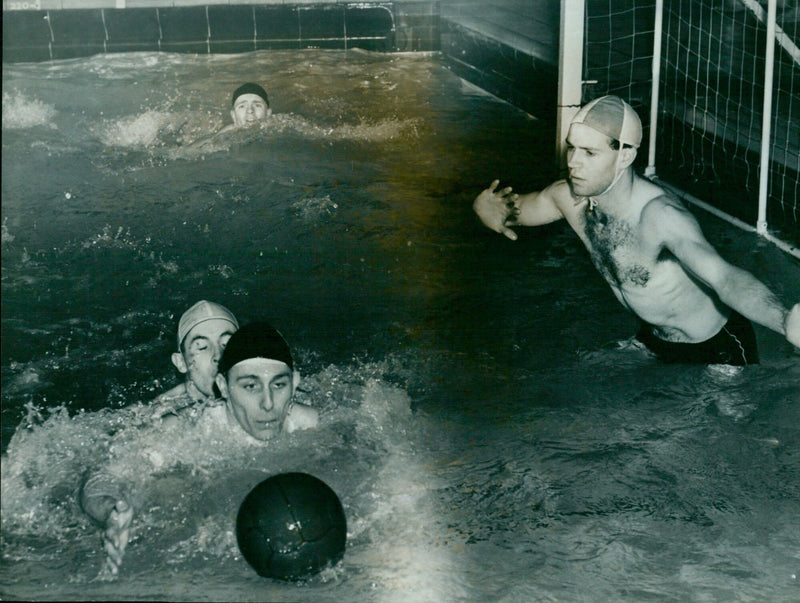 Oxford University and Metropolitan Police water polo teams compete in a match at Conley Battles on Thursday, February 15, 1958. - Vintage Photograph