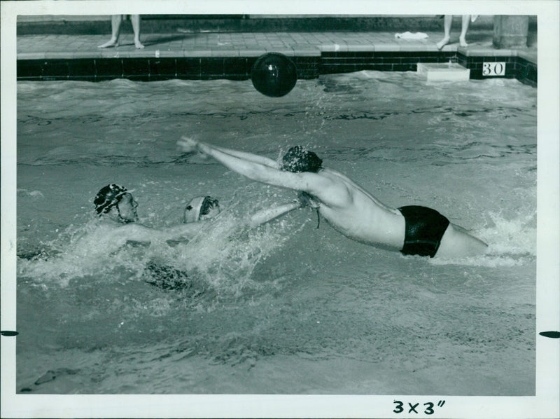 Oxford University Dolphins compete in a water polo match against King's College (London) at Temple Cowley Baths. - Vintage Photograph