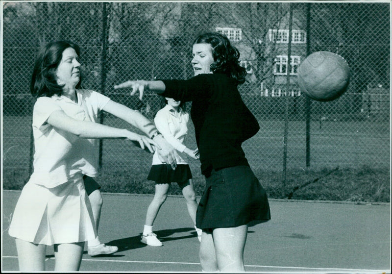 A group of people walking in a field on a sunny day. - Vintage Photograph