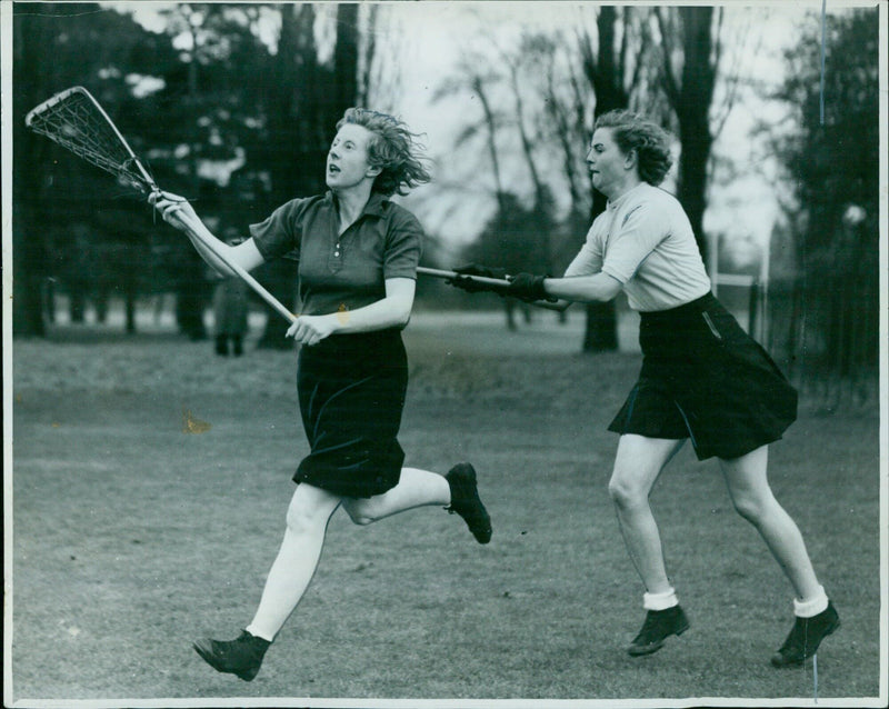 Miss V. Chevallier (Oxford) passes the ball while being defended by Miss J. Lancaster (Cambridge). - Vintage Photograph