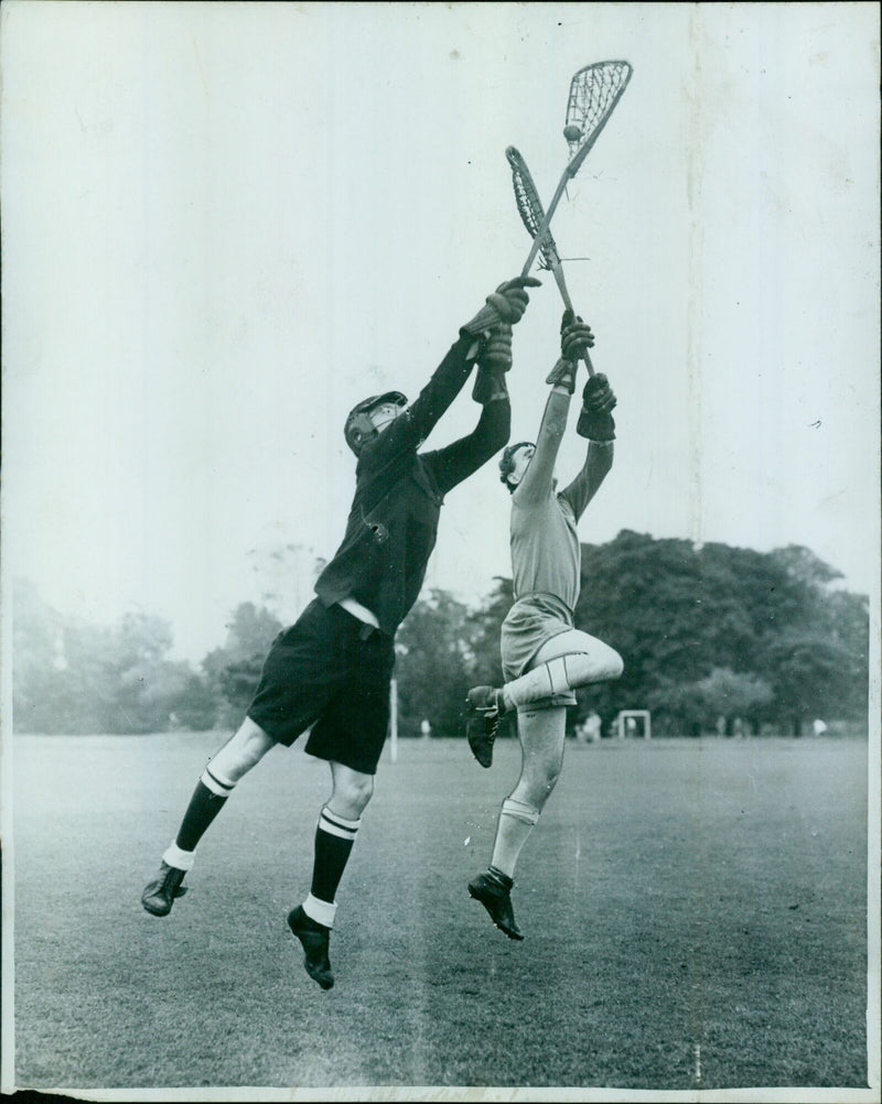 Oxford University lacrosse players Herb Benington (Pembroke) and Bruce Rosier (Christ Church) dueling for the ball during final trials. - Vintage Photograph