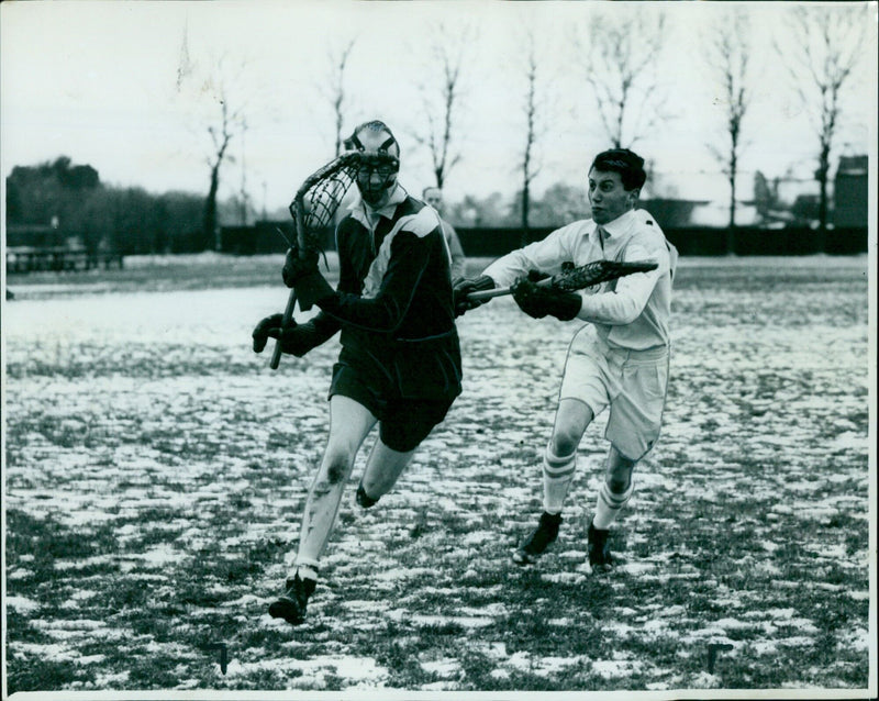 Cambridge player G. L. Hill attempts to retrieve the ball from Brasenose player H. Davidson in a close encounter. - Vintage Photograph