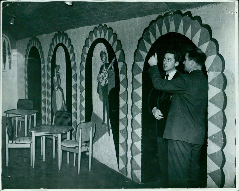 Mr. Leslie Crawte, the Union Steward, and Mr. Desmond Watkins, Treasurer of the Oxford Union Society, discuss preparations for the opening of their exotic Spanish-style cellar extensions. - Vintage Photograph