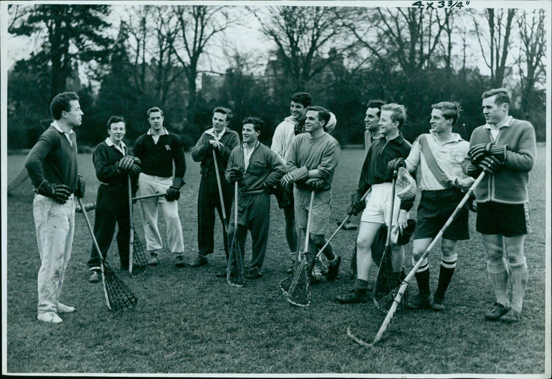 Oxford University lacrosse captain D.T. Wilkinson strategizing with his team. - Vintage Photograph