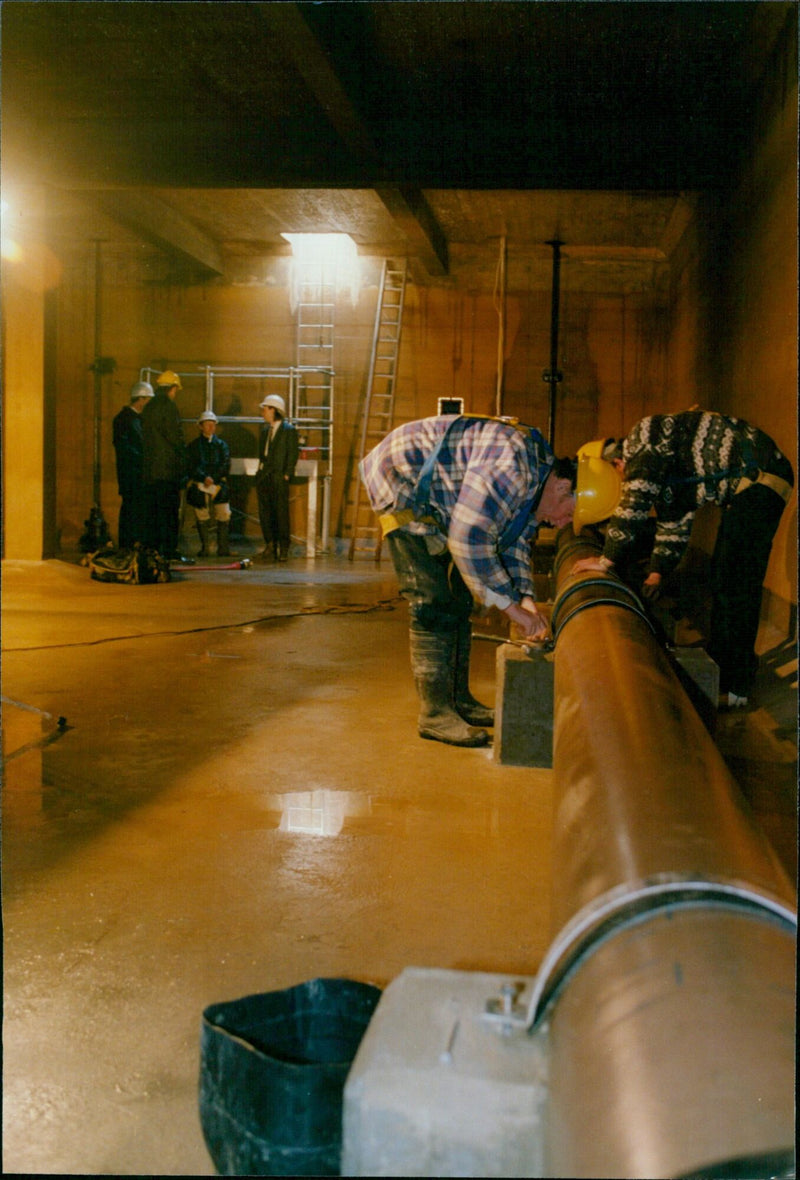 Workmen undertaking maintenance on pipes in the Ramsden Reservoir, Finstock. - Vintage Photograph