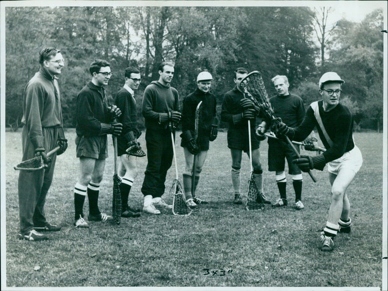 Oxford University Lacrosse Club captain instructs members in the art of passing the ball. - Vintage Photograph