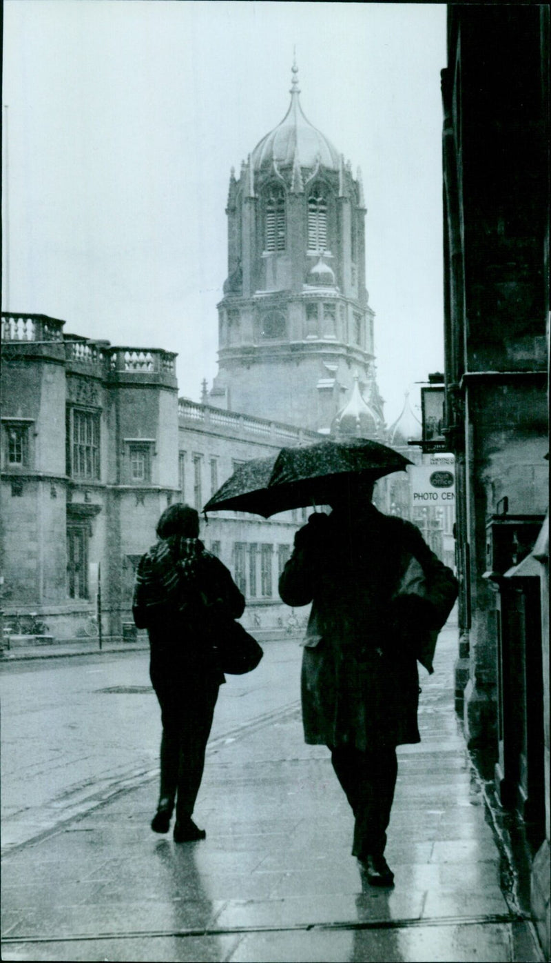 A woman and a child playing in the snow at Oxford St. Aldatef in Oxford, England. - Vintage Photograph