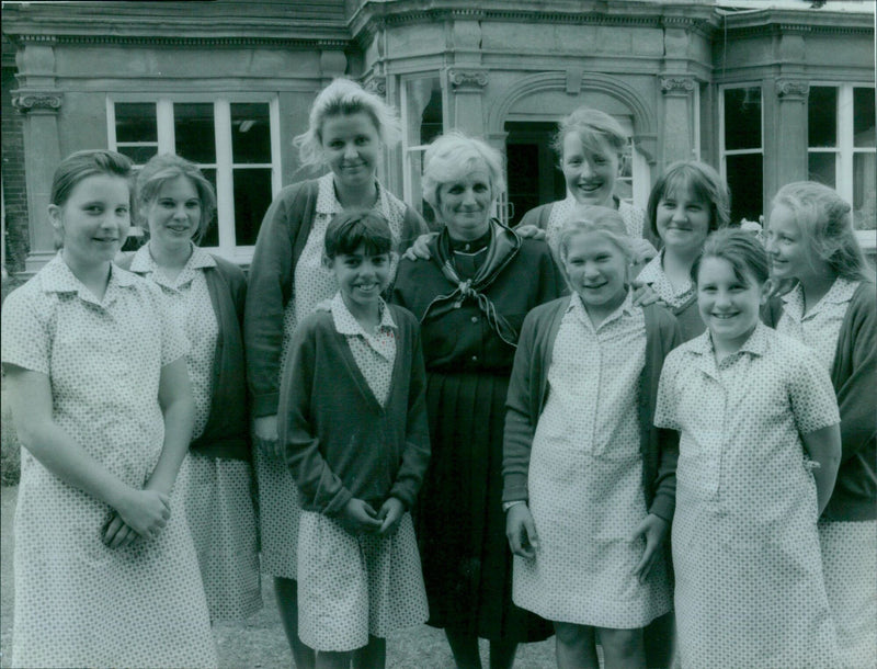 Ms. Patsy Sumpter, retiring head of Rye St. Antony School, poses with some of the pupils on the final day of her 63-year career. - Vintage Photograph