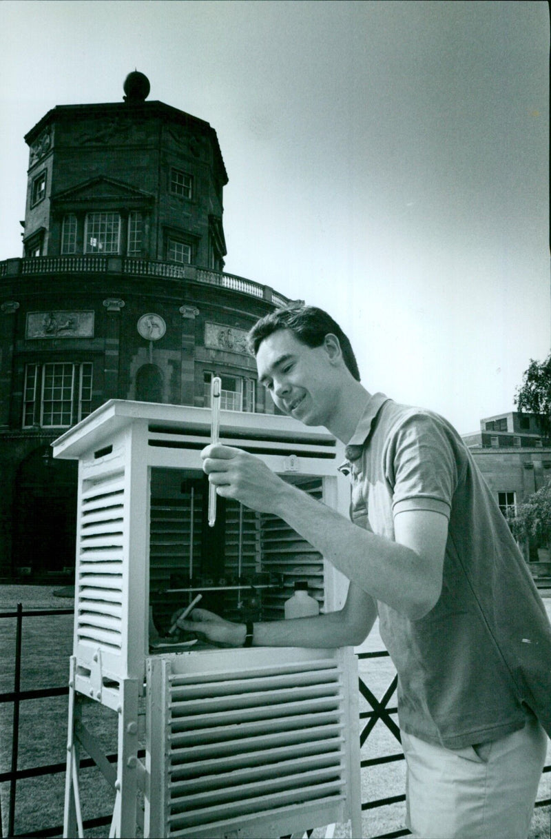 Oxford University researcher Tim Nightingale takes a temperature reading in the shadow of the Radcliffe Observatory. - Vintage Photograph