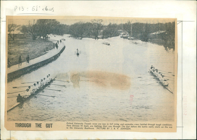 Despite challenging conditions, Division VI boats race through The Gut during the Oxford University Torpids races. - Vintage Photograph