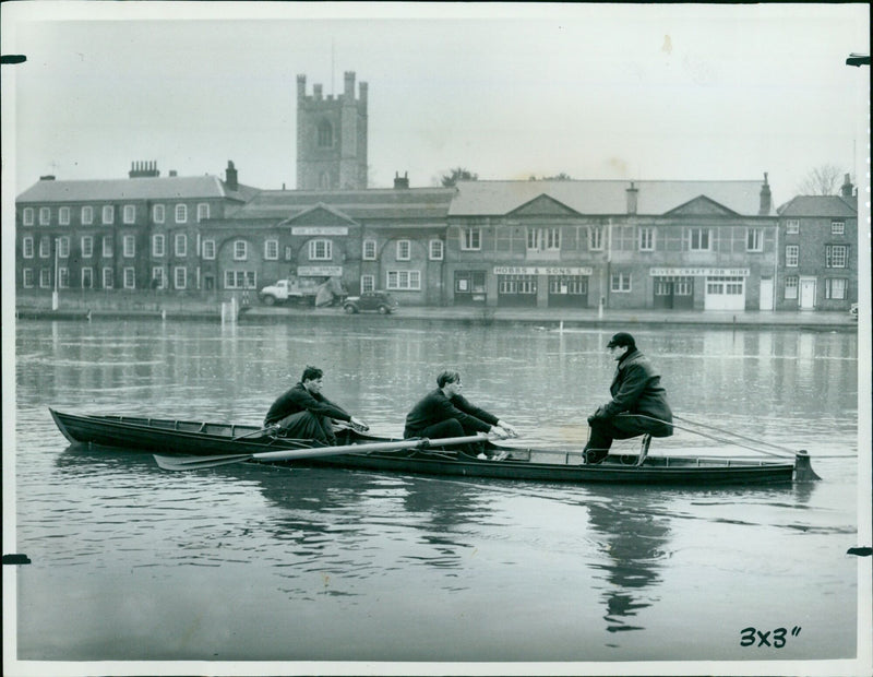 Mr. L. A. F. Stokes, president of Oxford University Boat Club, gives rowing practice to two of the Oxford oarsmen in Henley, England. - Vintage Photograph