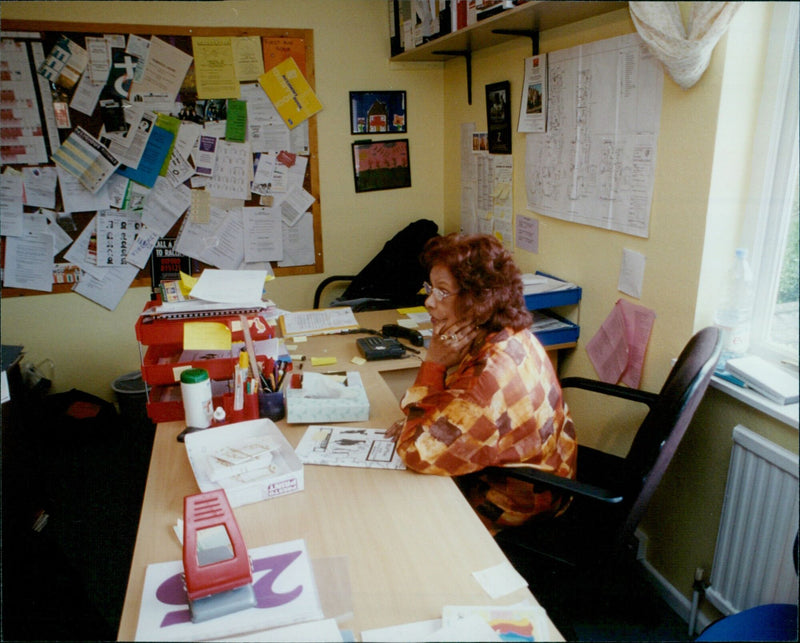 Two women look out from the window of an Oxford women's refuge. - Vintage Photograph