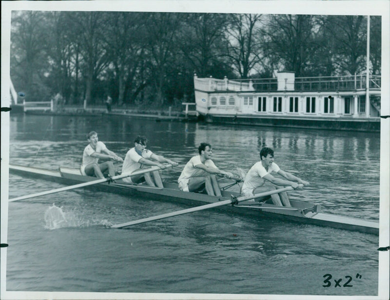 Keble College crew members, including three Olympic oarsmen, competing in a rowing heat against Brasenose College. - Vintage Photograph