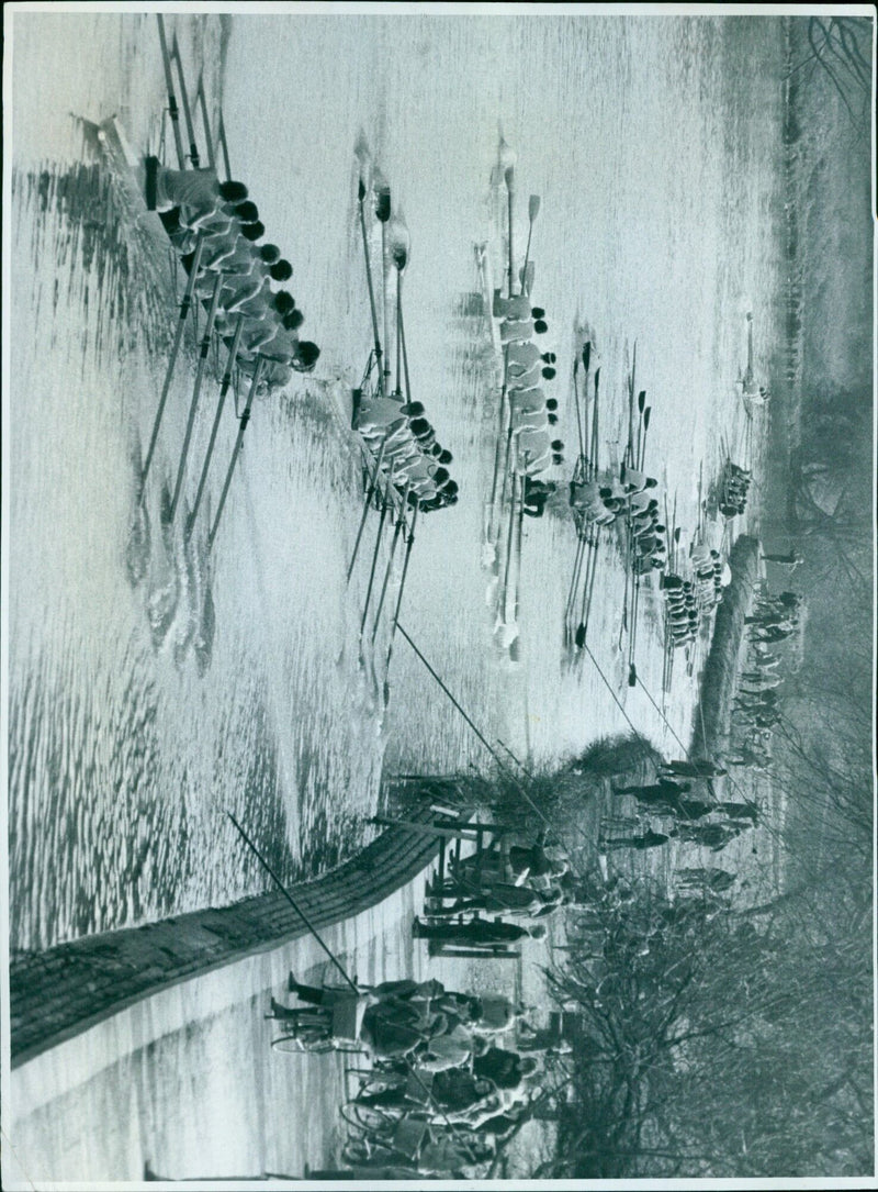 A woman stands in front of a massive iron structure in Oxford, Massachusetts. - Vintage Photograph