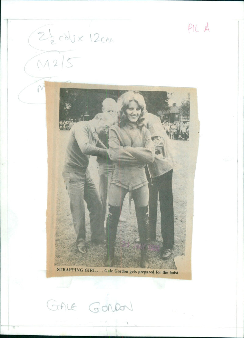 Actress Gale Gordon gets prepared for a hoist on set. - Vintage Photograph