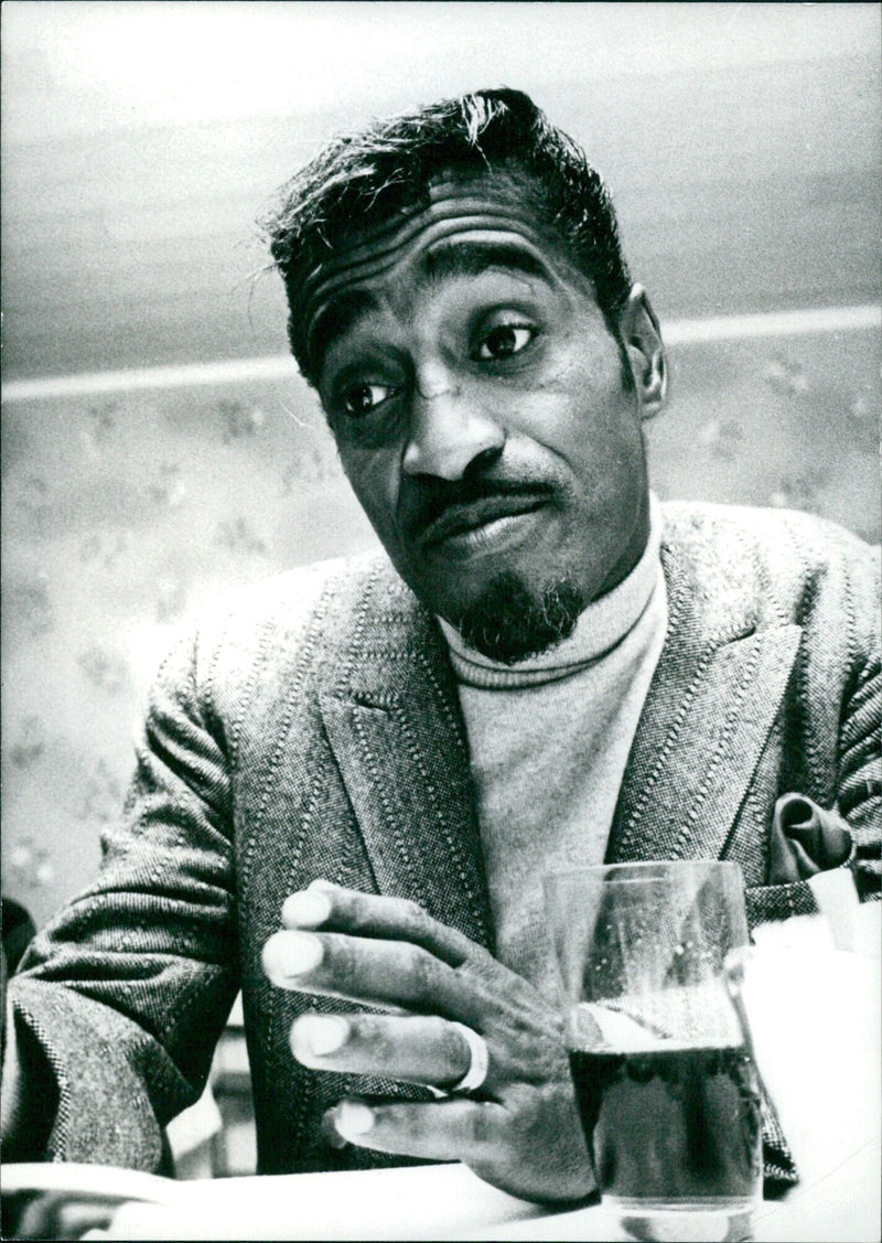 Sammy Davis Jr., renowned singer and comedian, poses for a portrait in 1957. - Vintage Photograph