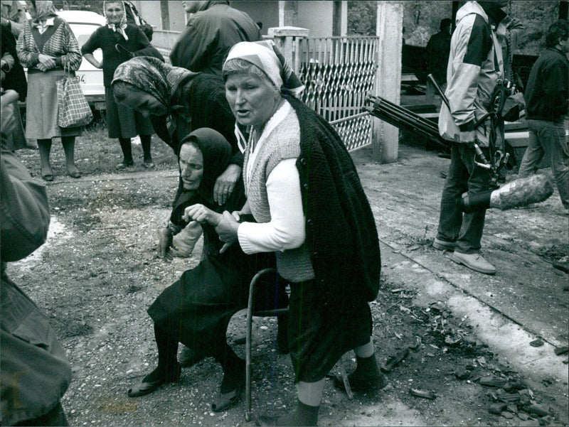 A woman stands in the ruins of a building destroyed during the Bosnian War in 1993. - Vintage Photograph