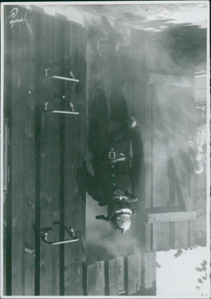 Members of the Röpenhamn Fire Department in Sweden are seen practicing firefighting maneuvers in 1936. - Vintage Photograph