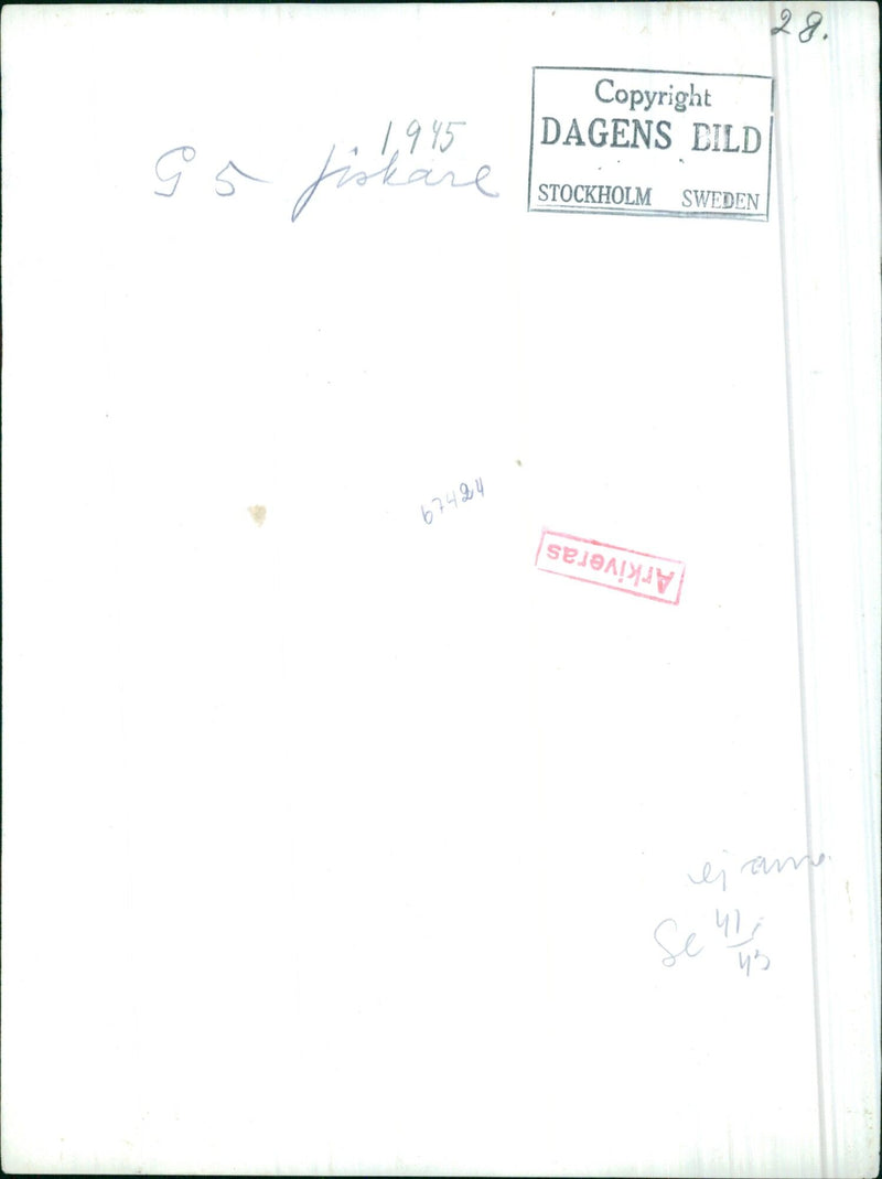 In this 1945 photo, a woman is seen walking past a destroyed building in Stockholm, Sweden. - Vintage Photograph