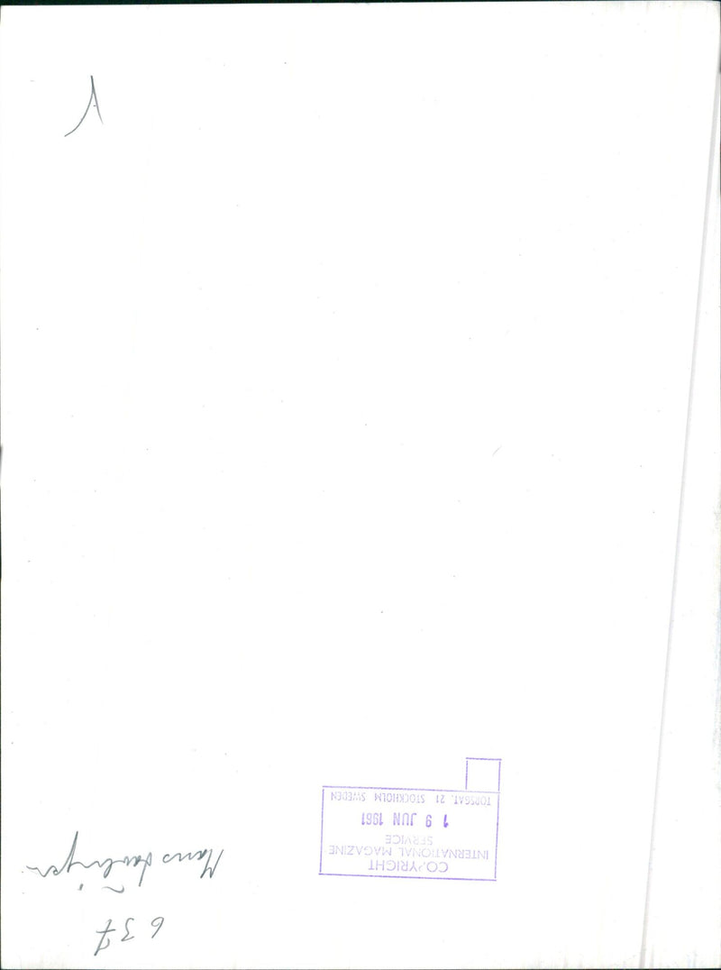 A man is seen walking on a street in Stockholm, Sweden on June 21, 1961. - Vintage Photograph