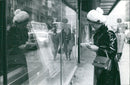A group of people gather in front of a building in Paris, France on November 1, 1970. - Vintage Photograph