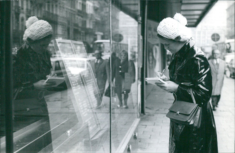 A group of people gather in front of a building in Paris, France on November 1, 1970. - Vintage Photograph