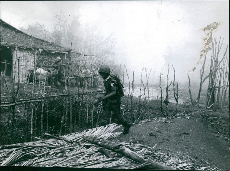 Vietnamese fishermen unloading their catch on the banks of the Mekong River in Torsgåt, Sweden on June 2, 2004. - Vintage Photograph