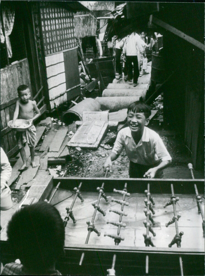 People gather in the streets of Saigon to celebrate the adoption of the 1954 constitution on November 22, 1953. - Vintage Photograph