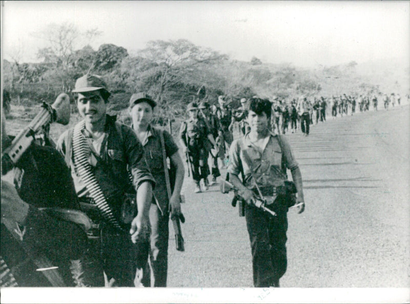 Members of the Rafael Antonio Arce Zablah Brigade of El Salvador's FMLN guerillas march in the east of the country in 1984. - Vintage Photograph